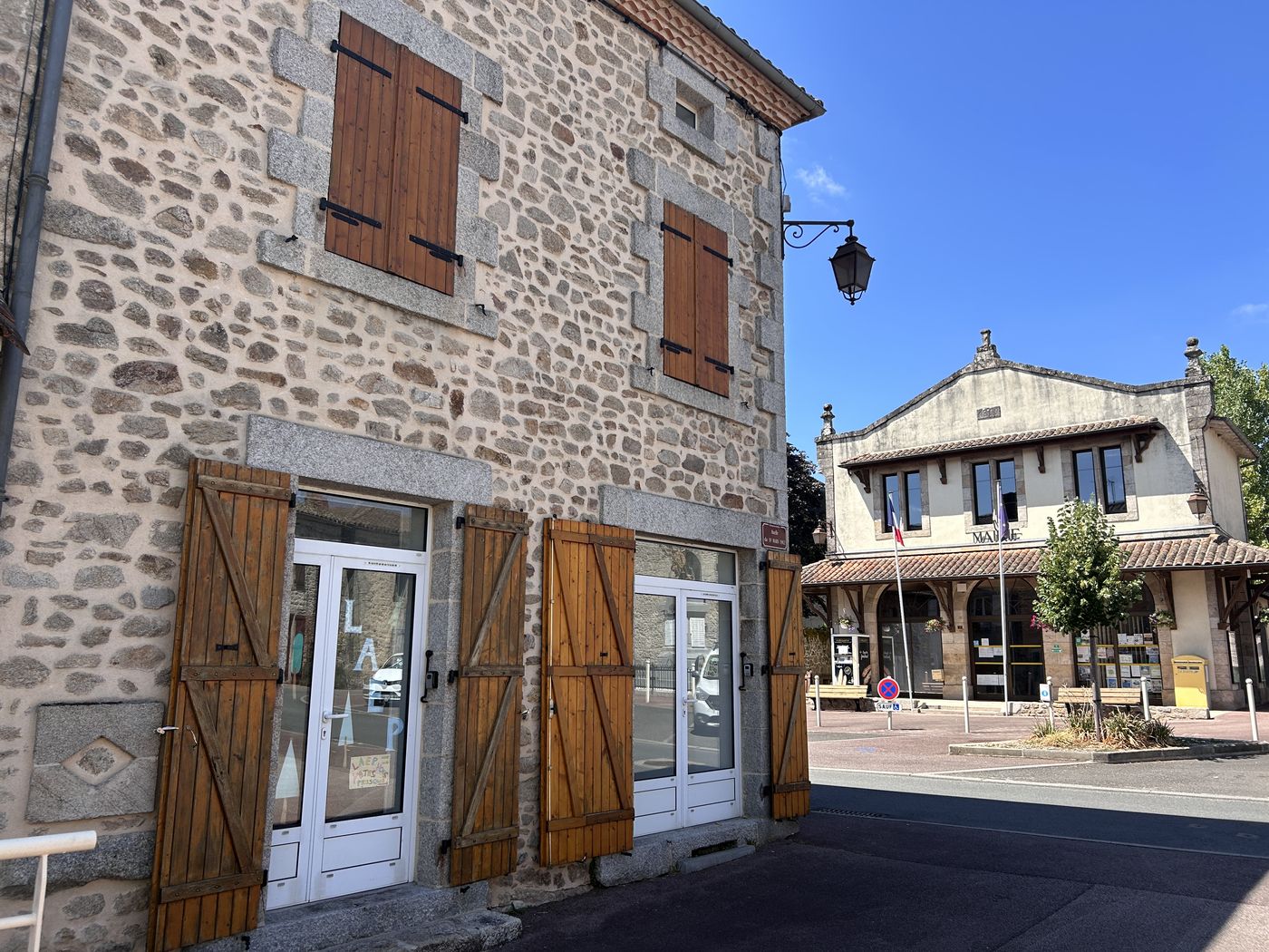 Le local du lieu d'accueil enfants-parents, au bourg, avec l'affiche LAEP en vitrine ; la mairie est visible en arrière-plan.